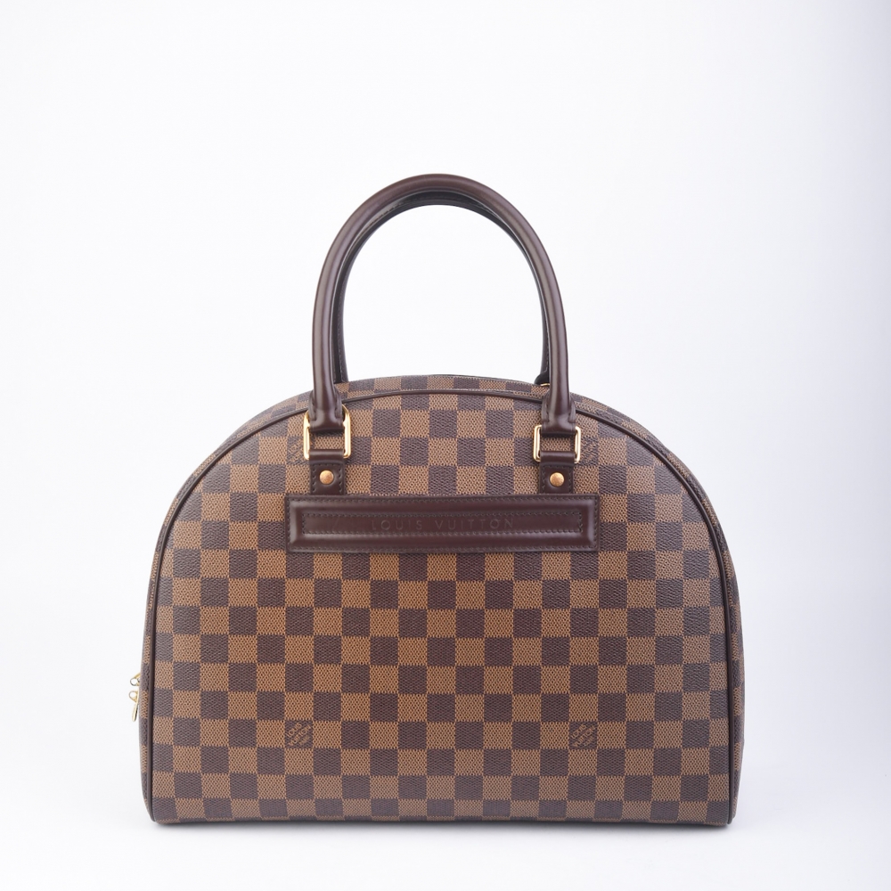 Louis Vuitton Nolita i Damier Ebene Canvas – laget i Frankrike i 2007. Denne modellen kombinerer strukturell eleganse med praktisk funksjonalitet og passer perfekt både til hverdags og mer formelle anledninger. Vesken har alle originale deler